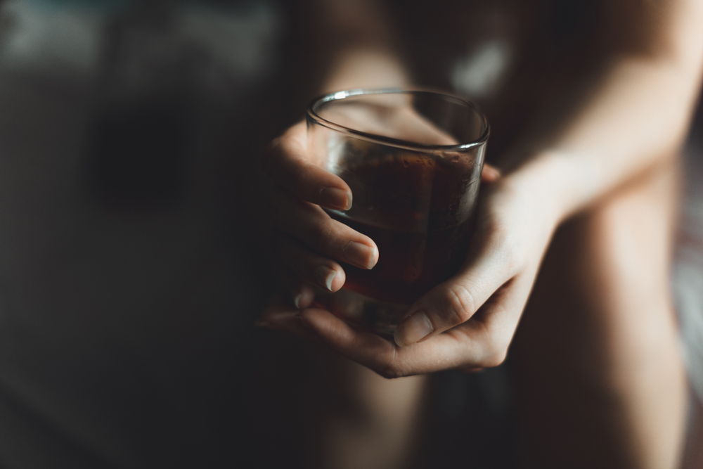 Woman holding glass of alcohol